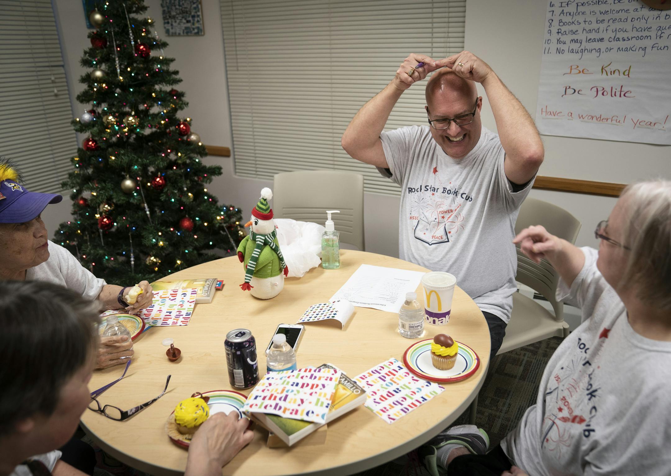 Jeff Hegna pretended he had a halo on his head as he goofed around with Susan Jelinki, right, during the Rock Star Book Club at Fraser in Apple Valley, Minn., on Tuesday, December 3, 2019. ] RENEE JONES SCHNEIDER &#xa5; renee.jones@startribune.com