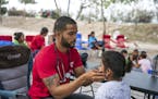 Dr. Dairon Elisondo Rojas, a doctor from Cuba, treats patients in a migrant camp in Matamoros, Mexico, Dec. 6, 2019. Rojas, waiting for asylum in the 