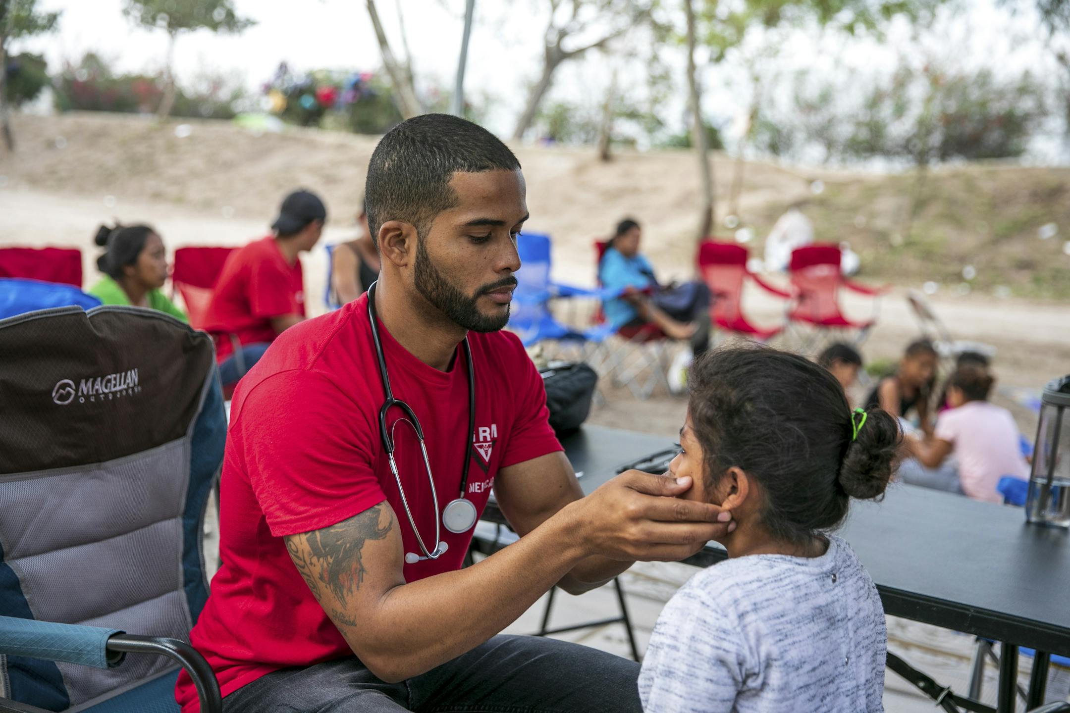Dr. Dairon Elisondo Rojas, a doctor from Cuba, treats patients in a migrant camp in Matamoros, Mexico, Dec. 6, 2019. Rojas, waiting for asylum in the United States, has become the only full-time physician at the makeshift encampment for 2,500 migrants in Mexico. (Ilana Panich-Linsman/The New York Times) ORG XMIT: MER0356f73f24a84884922c88827cf0a