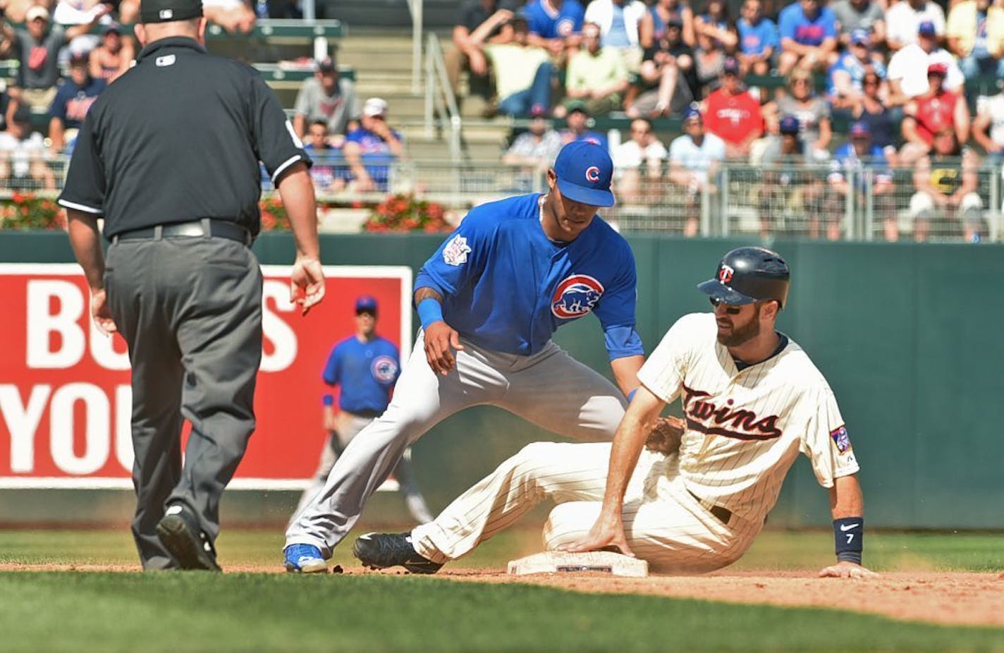 Minnesota Twins base runner Joe Mauer gets his hand back down on second base too late and is called out on a steal attempt after Chicago Cubs second baseman Addison Rusell tags him out in the ninth inning of a baseball game, Saturday June 20, 2015, in Minneapolis. Chicago won 4-1 in 10 innings.