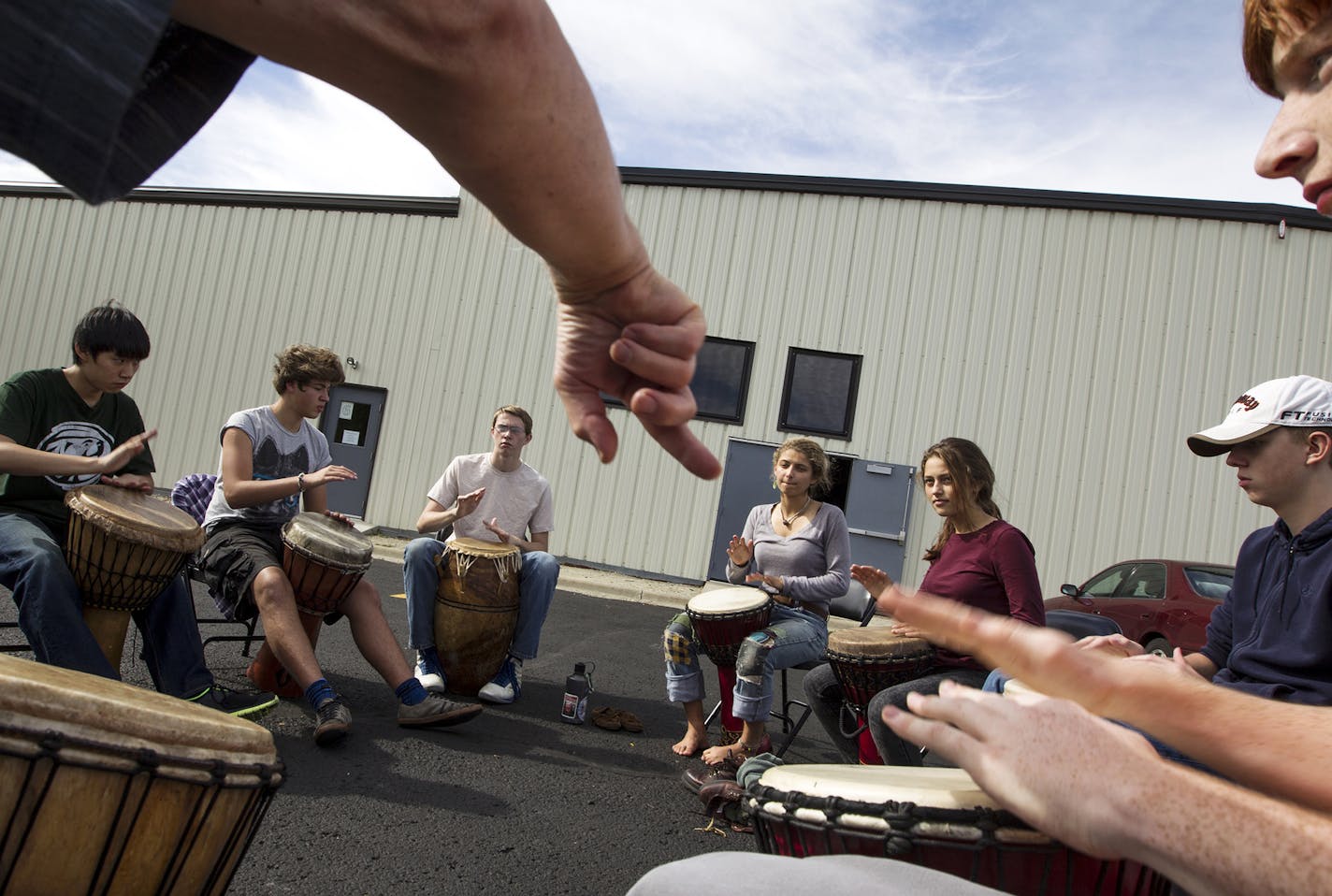 Teacher Bob Gregory-Bjorklund (arm) points for two students to follow his rhythmic lead during an African drumming class at Arcadia Charter School in Northfield October 8, 2013. (Courtney Perry/Special to the Star Tribune)