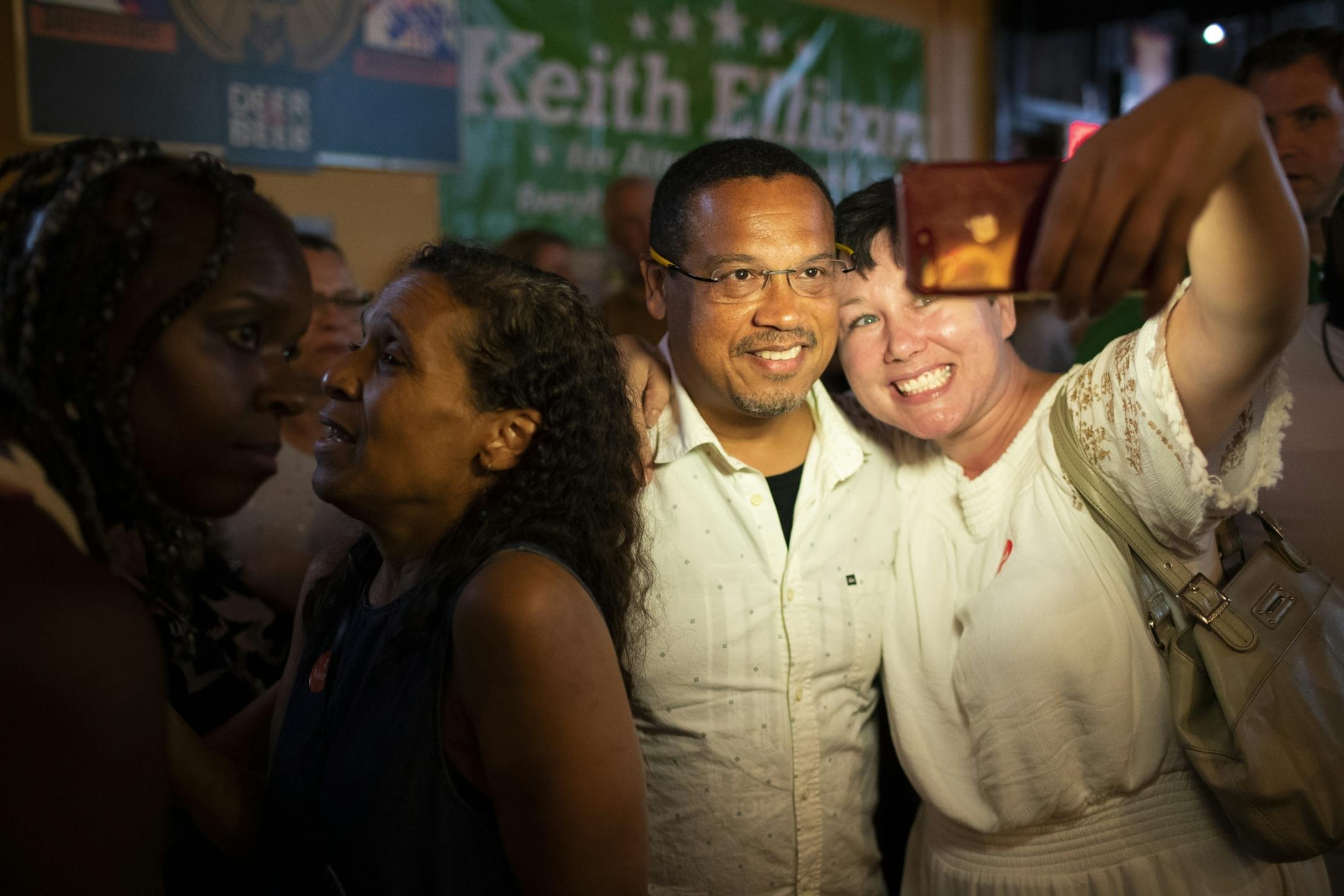 Rep. Keith Ellison posed for a selfie with Jennifer Lindquist after winning the democratic nomination for Attorney General during primary party at Nomad World Pub in Minneapolis, Minn., on August 14, 2018. At left is Ellison's ex-wife Kim Ellison who came to support him after abuse allegations from a former girlfriend earlier this week.