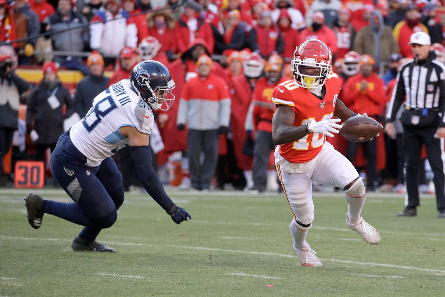 Kansas City wide receiver Tyreek Hill runs away from Tennessee linebacker Harold Landry III during the AFC Championship Game