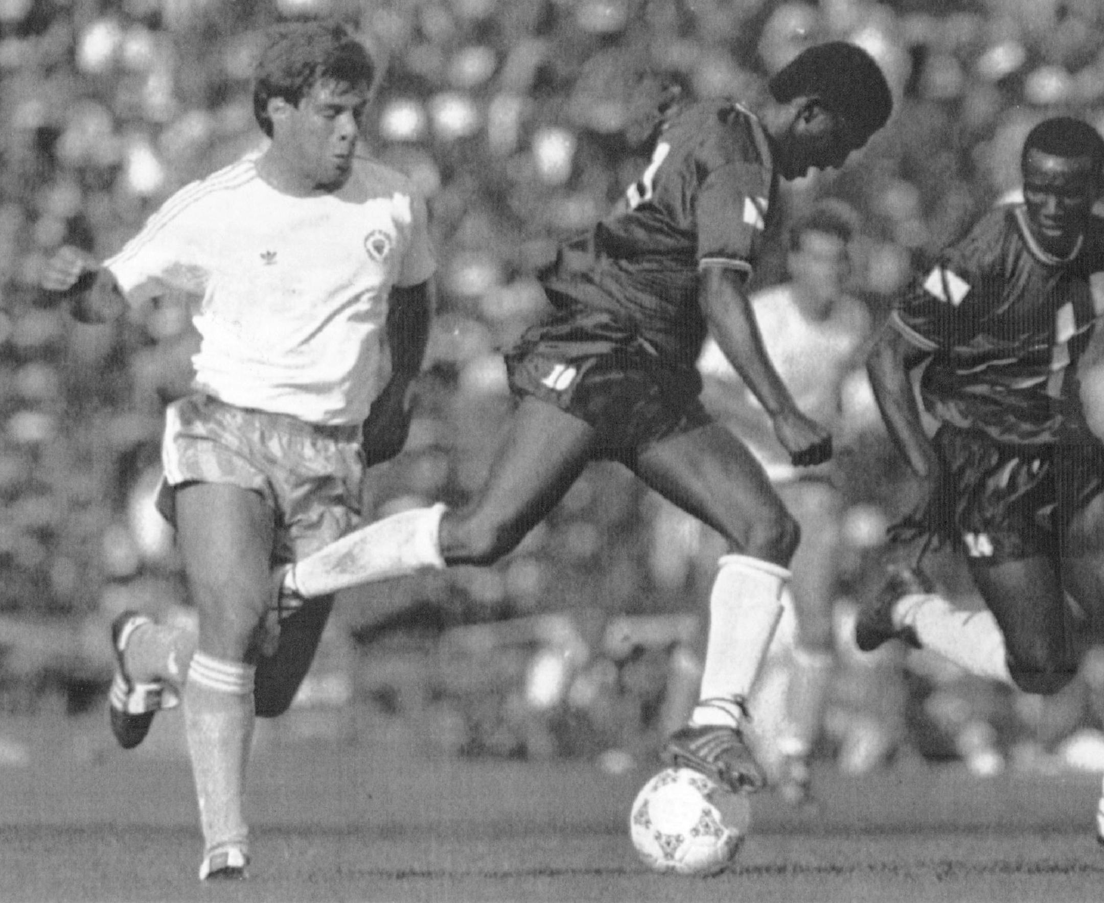 November 19, 1989 Caligiuri Vs Latapy--Paul Caligiuri, left, of the United States, and Russell Latapy, center, of Trinidad and Tobago fight for control of the ball at National Stadium in Port - of-Spain on Sunday. Caligiuri scored the game's only goal as the U.S. won, 1-0. The U.S. advances to the 1990 World Cup in Italy. At right is Philbert Jones of Trinidad and Tobago. November 20, 1989 Mark Lennihan, AP LaserColor ORG XMIT: MIN2016111117503737