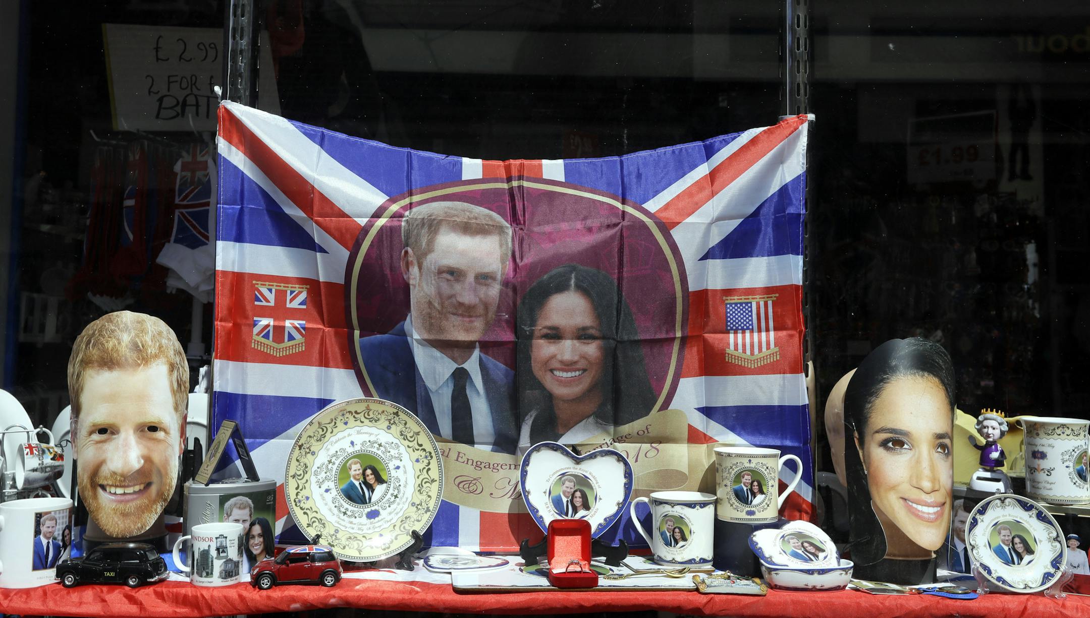 Merchandise is displayed for sale in a shop window in Windsor, England, Monday, May 14, 2018. Preparations are being made in the town ahead of the wedding of Britain's Prince Harry and Meghan Markle that will take place in Windsor on Saturday May 19. (AP Photo/Kirsty Wigglesworth)
