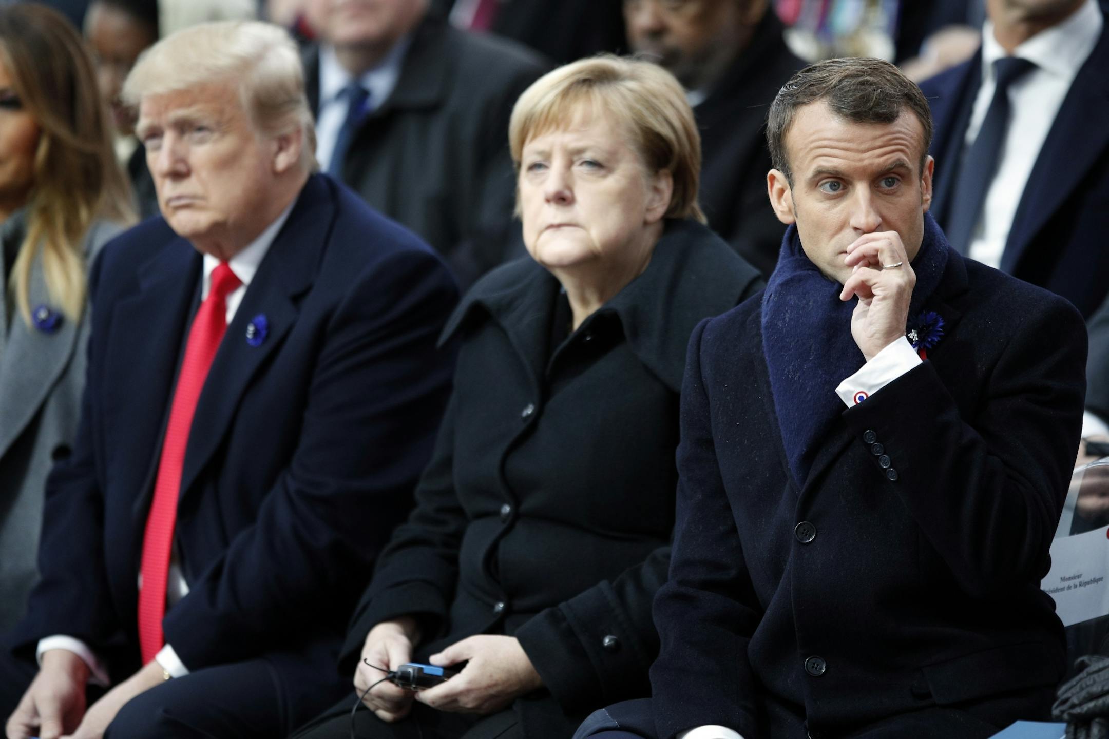 U.S President Donald Trump, left, German Chancellor Angela Merkel and French President Emmanuel Macron attend ceremonies at the Arc de Triomphe Sunday, Nov. 11, 2018 in Paris. Over 60 heads of state and government were taking part in a solemn ceremony at the Tomb of the Unknown Soldier, the mute and powerful symbol of sacrifice to the millions who died from 1914-18..