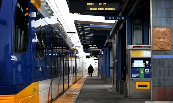 A passenger walks on the platform of Metro Green Line's westbound Victoria Street station in St. Paul on Monday, December 8, 2014. ] LEILA NAVIDI leil