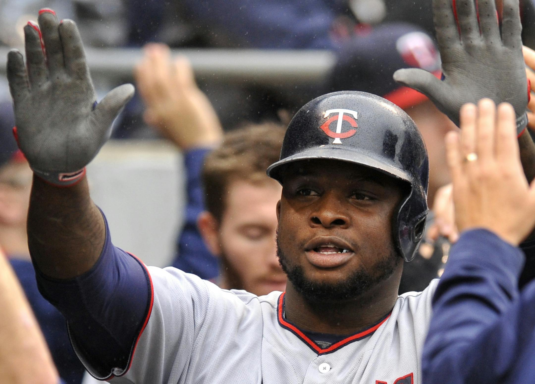 Minnesota Twins' Miguel Sano (22) celebrates with teammates in the dugout after hitting a three-run home run during the third inning of a baseball game against the Chicago White Sox, Sunday, Oct. 2, 2016, in Chicago. (AP Photo/Paul Beaty)