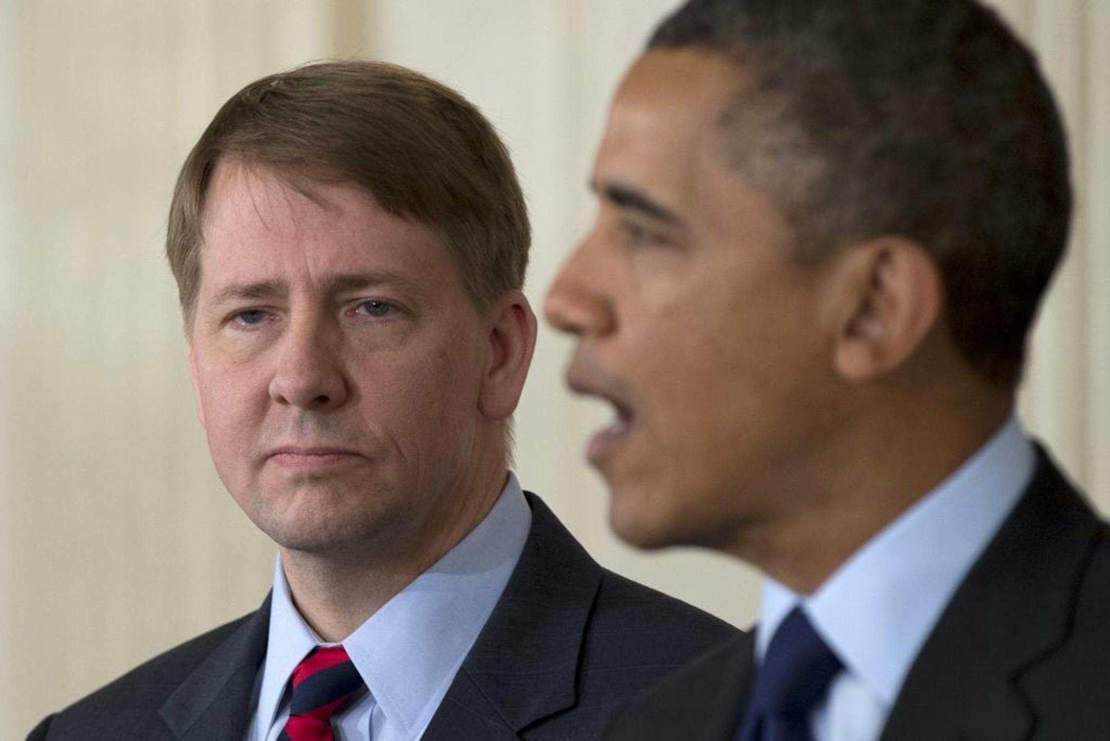 Richard Cordray stands left as President Barack Obama announces in the State Dining Room of the White House in Washington, Thursday, Jan. 24, 2013, that he will re-nominate Cordray to lead the Consumer Financial Protection Bureau, a role that he has held for the last year under a recess appointment, and nominate Mary Joe White to lead the Security and Exchange Commission (SEC).