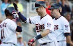 Twins first baseman Joe Mauer celebrated his grand slam with Jorge Polanco in the fifth inning at Target Field on Sunday