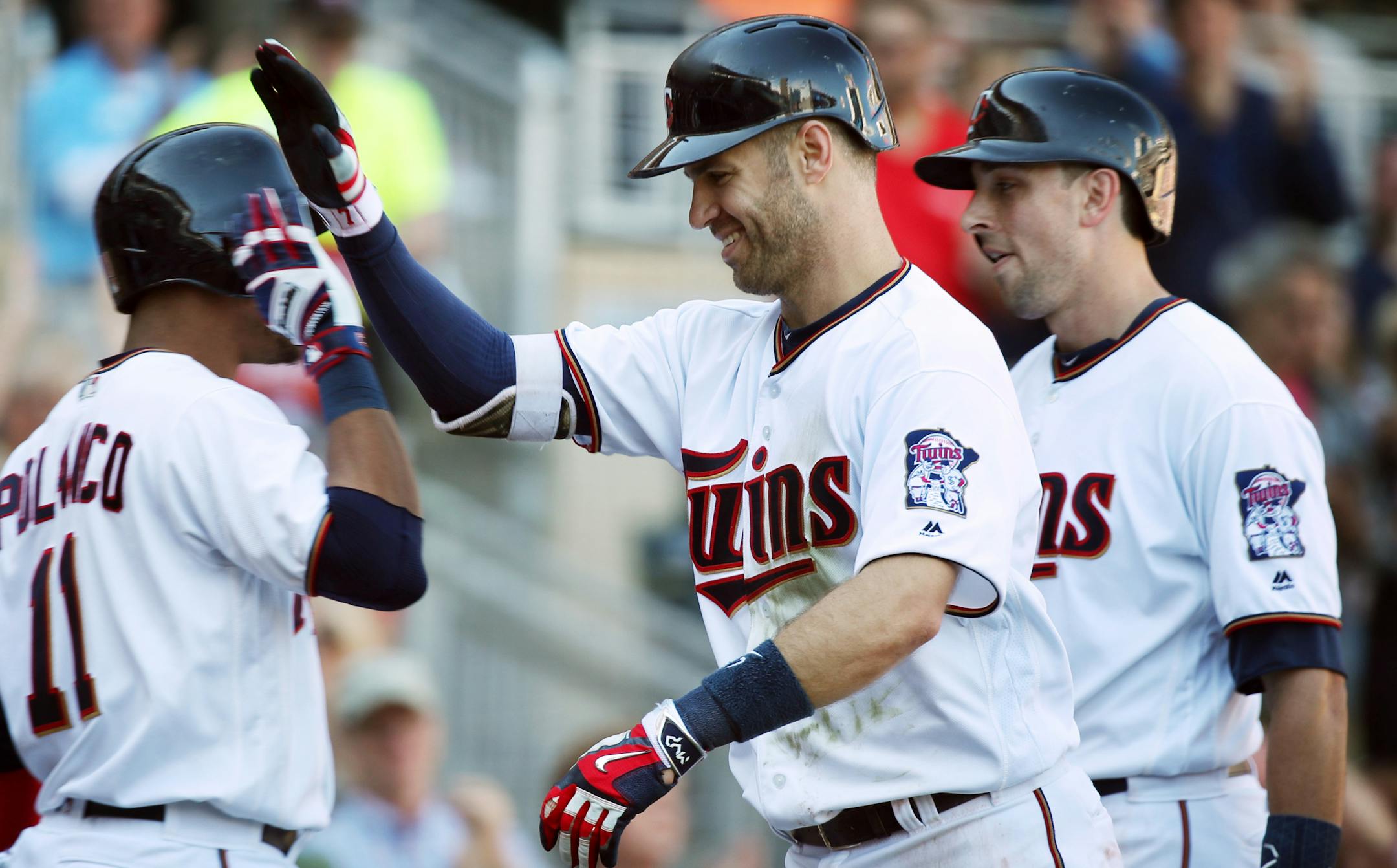 Twins first baseman Joe Mauer celebrated his grand slam with Jorge Polanco in the fifth inning at Target Field on Sunday