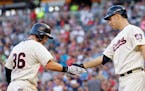 Minnesota Twins Robbie Grossman (36) is congratulated by teammate' Joe Mauer after hitting a home run against the Kansas City Royals in the fifth inni