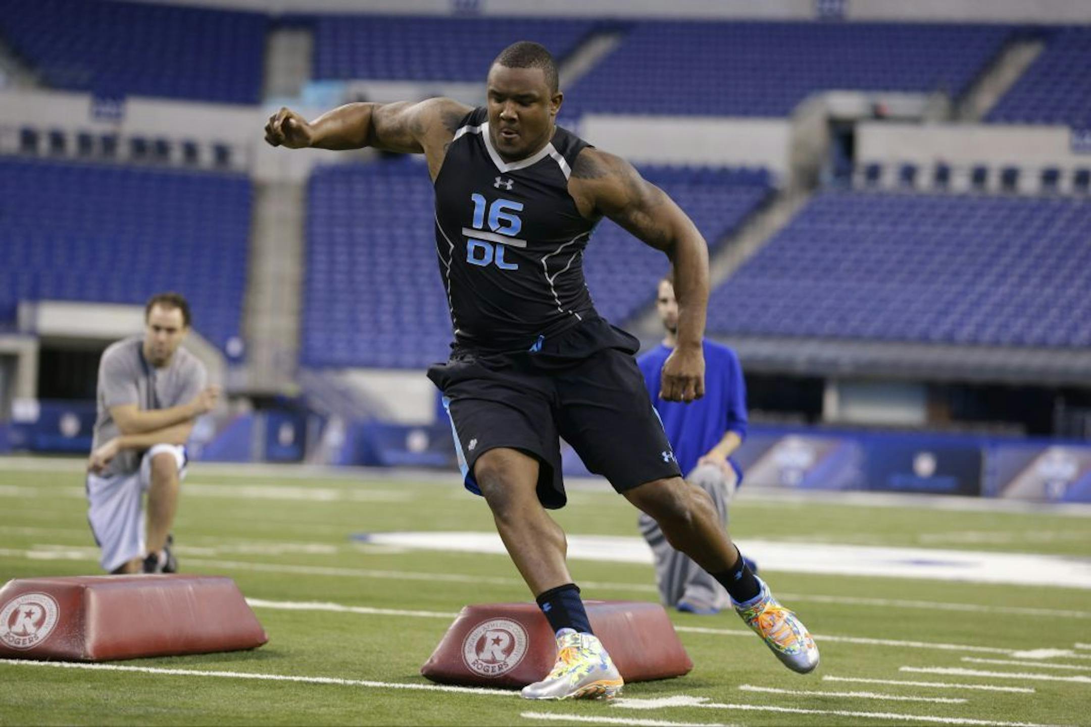 Minnesota defensive lineman Ra'Shede Hageman runs a drill at the NFL football scouting combine in Indianapolis, Monday, Feb. 24, 2014.
