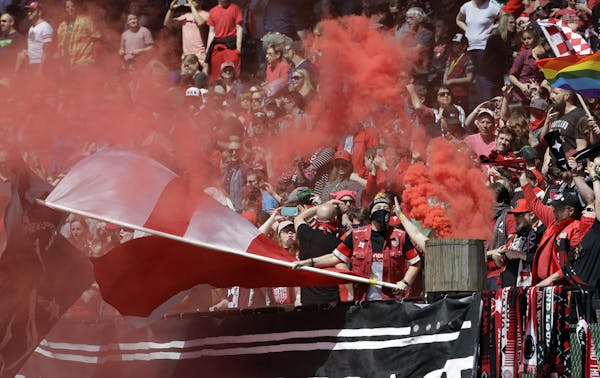Portland Thorns fans celebrate after a score during the first half of an NWSL soccer match against the Orlando Pride in Portland, Ore., Saturday, Apri