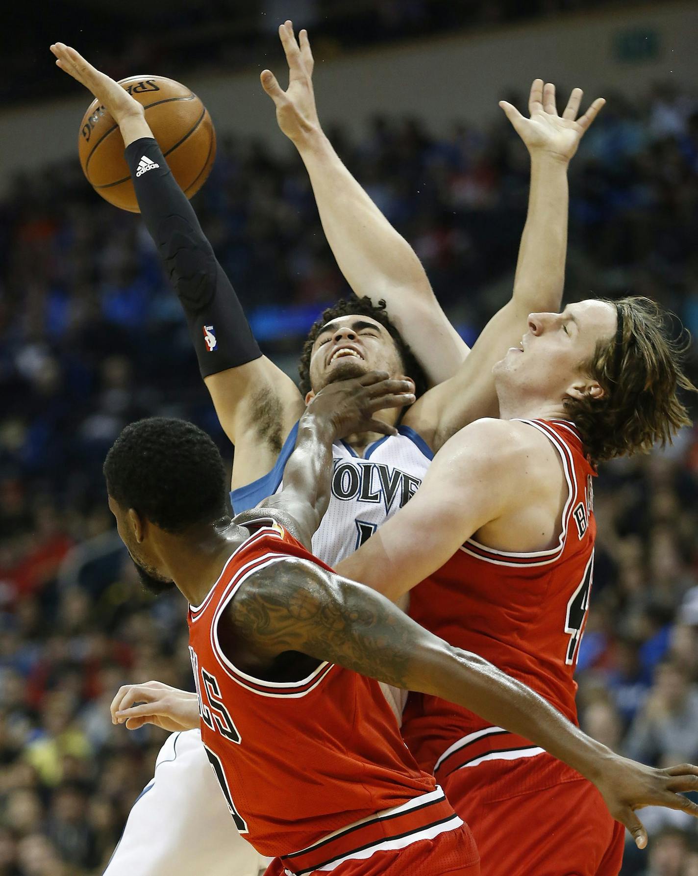 Minnesota Timberwolves' Tyus Jones, center, gets fouled by Chicago Bulls' Aaron Brooks, left, and Cameron Bairstow (41) during the first half of an NBA preseason basketball game, Saturday, Oct. 10, 2015 in Winnipeg, Manitoba. (John Woods/The Canadian Press via AP) MANDATORY CREDIT