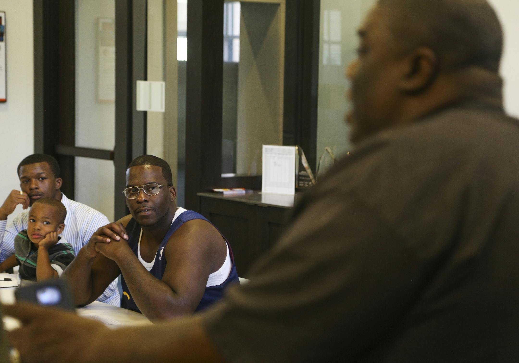Caliph Conner, far left, and Charles Bickham, right, key in while Ferome Brown speaks to his group of mentors-in-training on June 30, 2016.