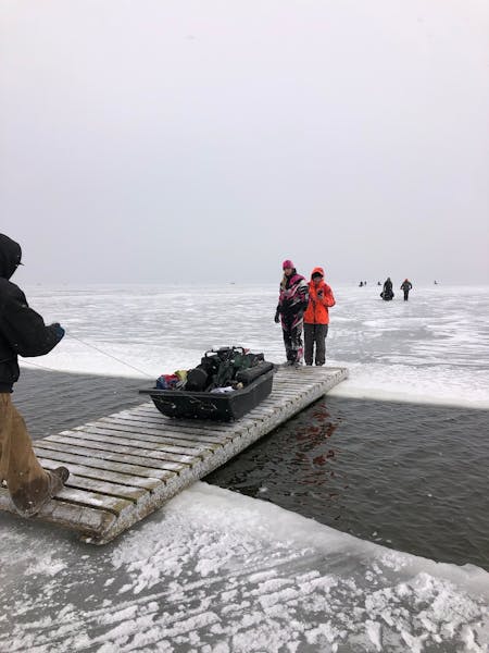 Anglers evacuated a sheet of ice using a bridge provided by JR’s Corner Access resort on the south side of Upper Red Lake on Monday.