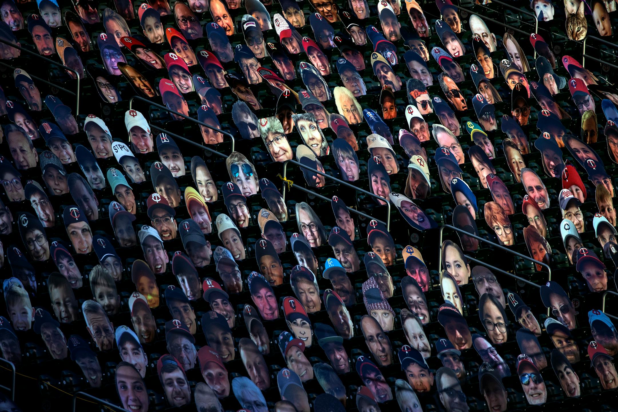 Carboard cutouts of fan faces in the stands of Target Field