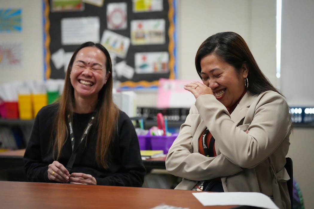 Teacher Narene Canindo, left, and paraprofessional Jessie Jane Marapao share a laugh at the end of a school day at Fridley Middle School in Fridley on Tuesday.