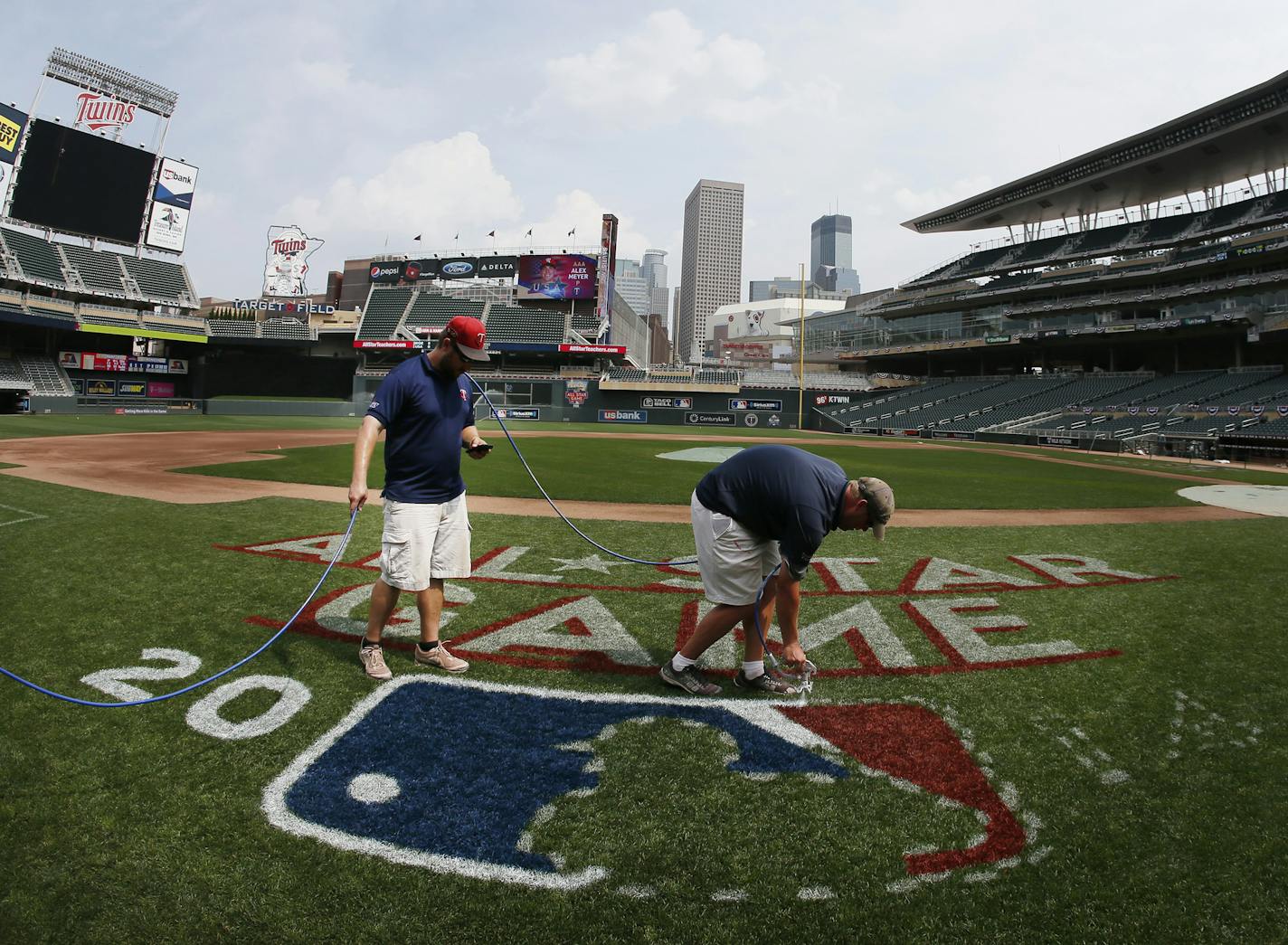 Nick Wilz left and Ryan Rowland members of the ground crew at Target Filed, painted the MLB All Star logo during preparation for the 2014 Major League baseball All Star Game at Target Field Thursday July 10, 2014 in Minneapolis, MN. ] Jerry Holt Jerry.holt@startribune.com