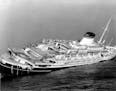 FILE - In this July 26, 1956 file photo, the Italian luxury liner Andrea Doria keels far over to starboard before sinking 225 feet to the bottom of th