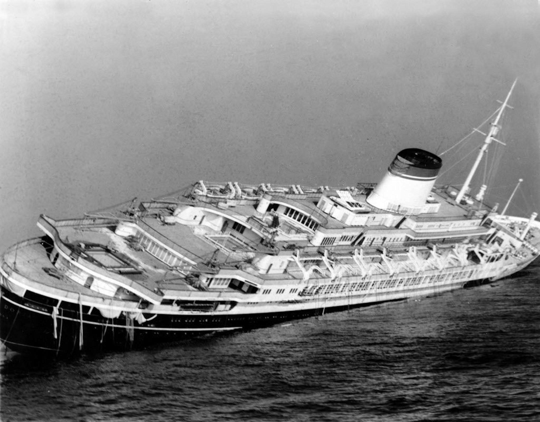 FILE - In this July 26, 1956 file photo, the Italian luxury liner Andrea Doria keels far over to starboard before sinking 225 feet to the bottom of the Atlantic 45 miles off Nantucket Island, Mass. Nearly six decades after the Andrea Doria slammed into another ocean liner, killing 46 people, explorers are preparing to do what 16 others have lost their lives attempting: get a fresh glimpse of the wreckage on the sea floor. Everett, Washington-based OceanGate will use a five-person submarine in Ju