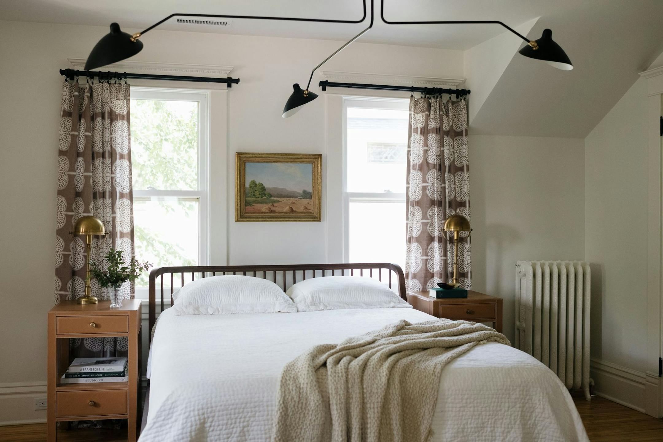 Two windows and a radiator limited where the bed could go, so a low spindle headboard was chosen to avoid blocking light from the windows.