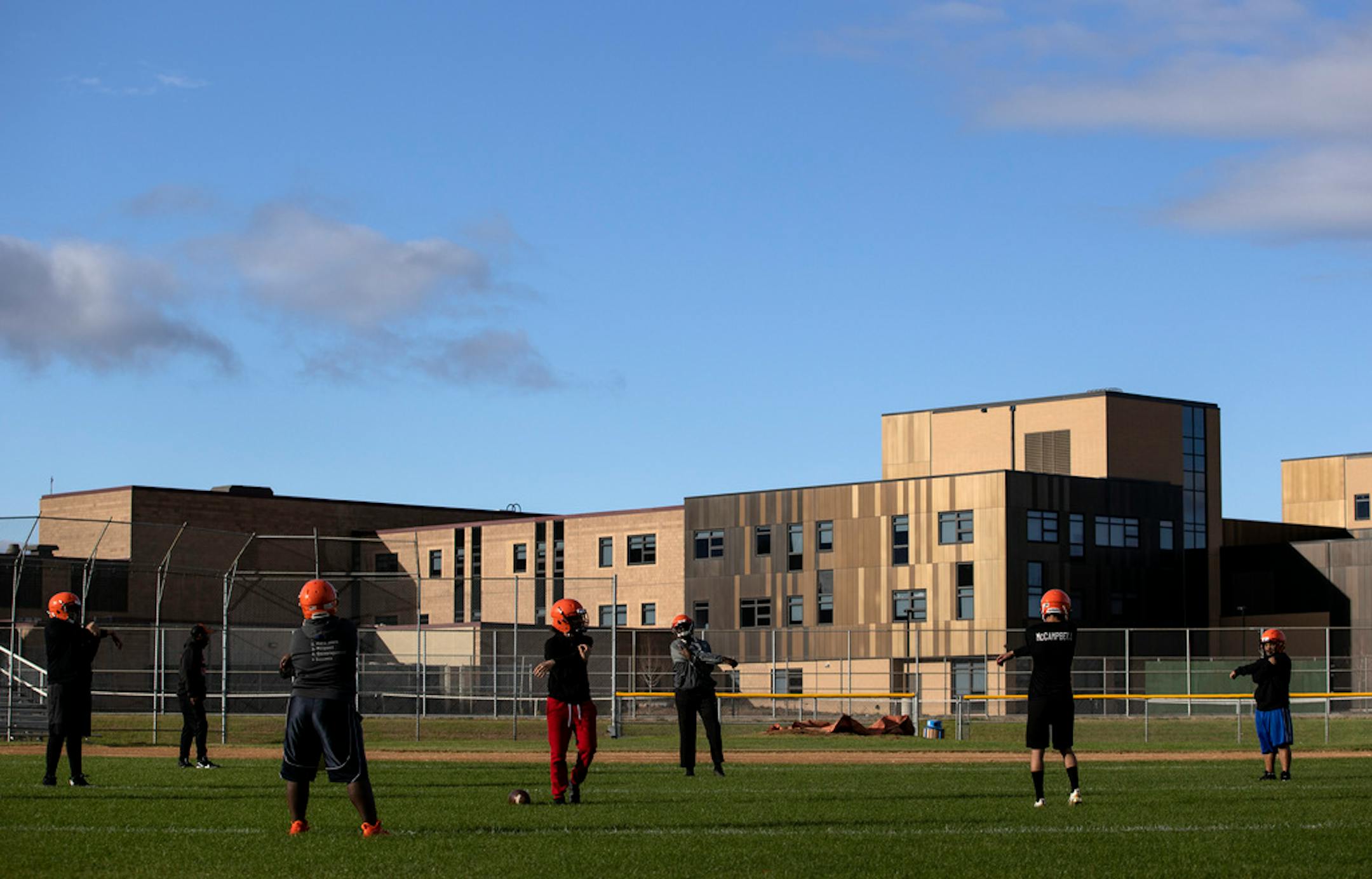 Football players stretched out during practice Sept. 28 at Humboldt High School in St. Paul.