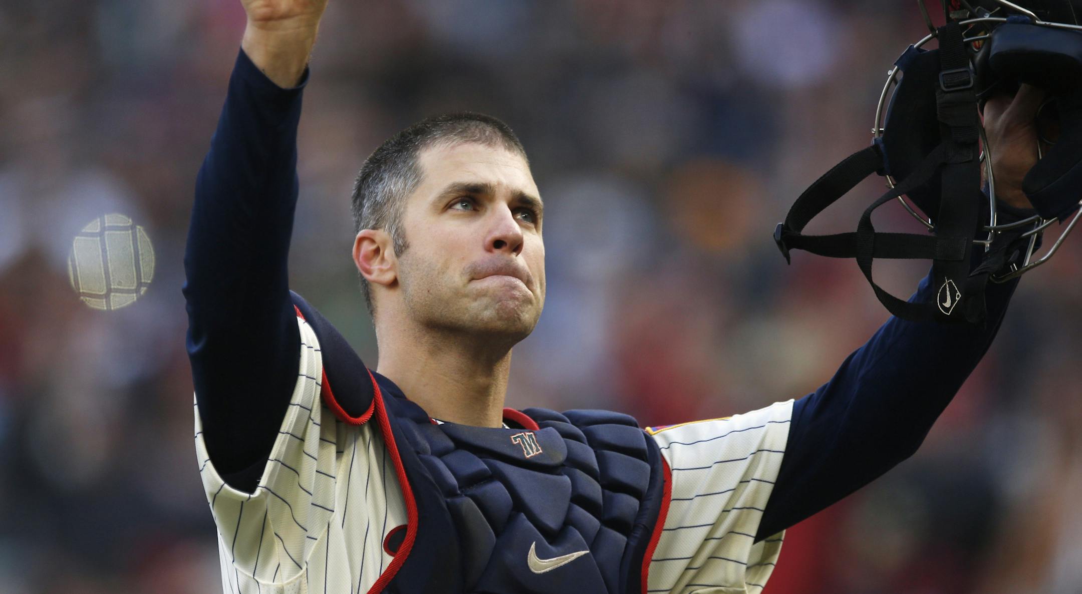 Joe Mauer acknowledges a standing ovation as he donned catcher's gear and caught for one pitch against the Chicago White Sox