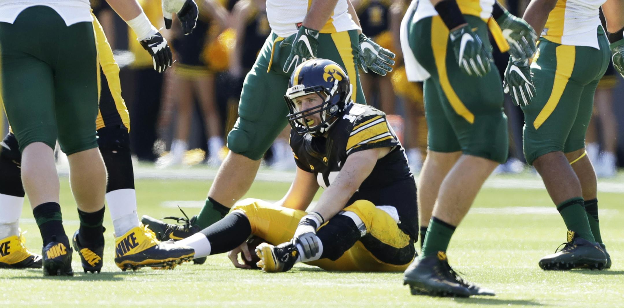 Iowa quarterback C.J. Beathard sits on the field after recovering a bad snap during the second half of an NCAA college football game against North Dakota State, Saturday, Sept. 17, 2016, in Iowa City, Iowa. North Dakota State won 23-21. (AP Photo/Charlie Neibergall) ORG XMIT: IACN111