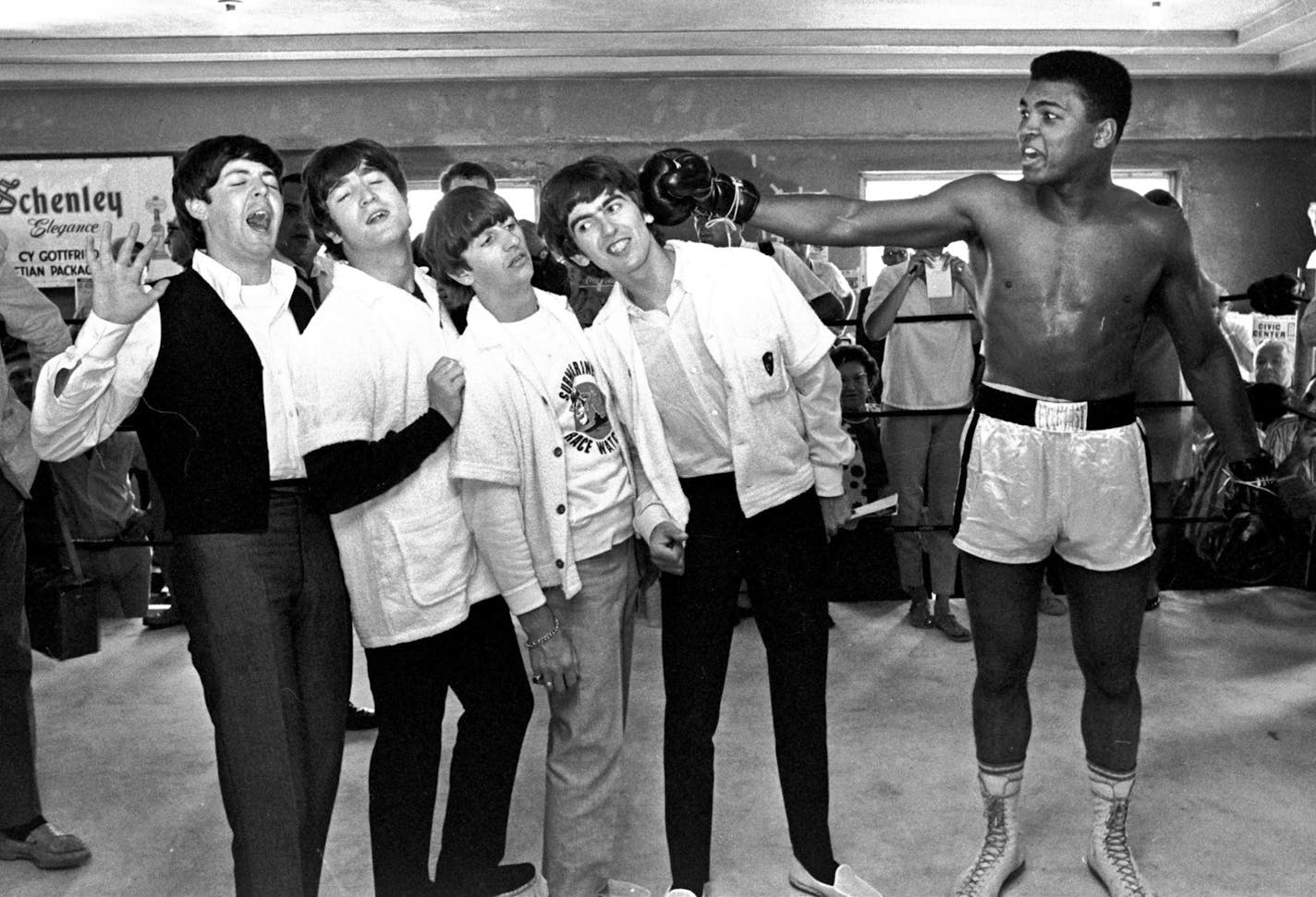 FILE - In this Feb. 18, 1964, file photo, The Beatles, from left, Paul McCartney, John Lennon, Ringo Starr, and George Harrison, take a fake blow from Cassius Clay, who later changed his name to Muhammad Ali, while visiting the heavyweight contender at his training camp in Miami Beach, Fla. Ali turns 70 on Jan. 17, 2012.