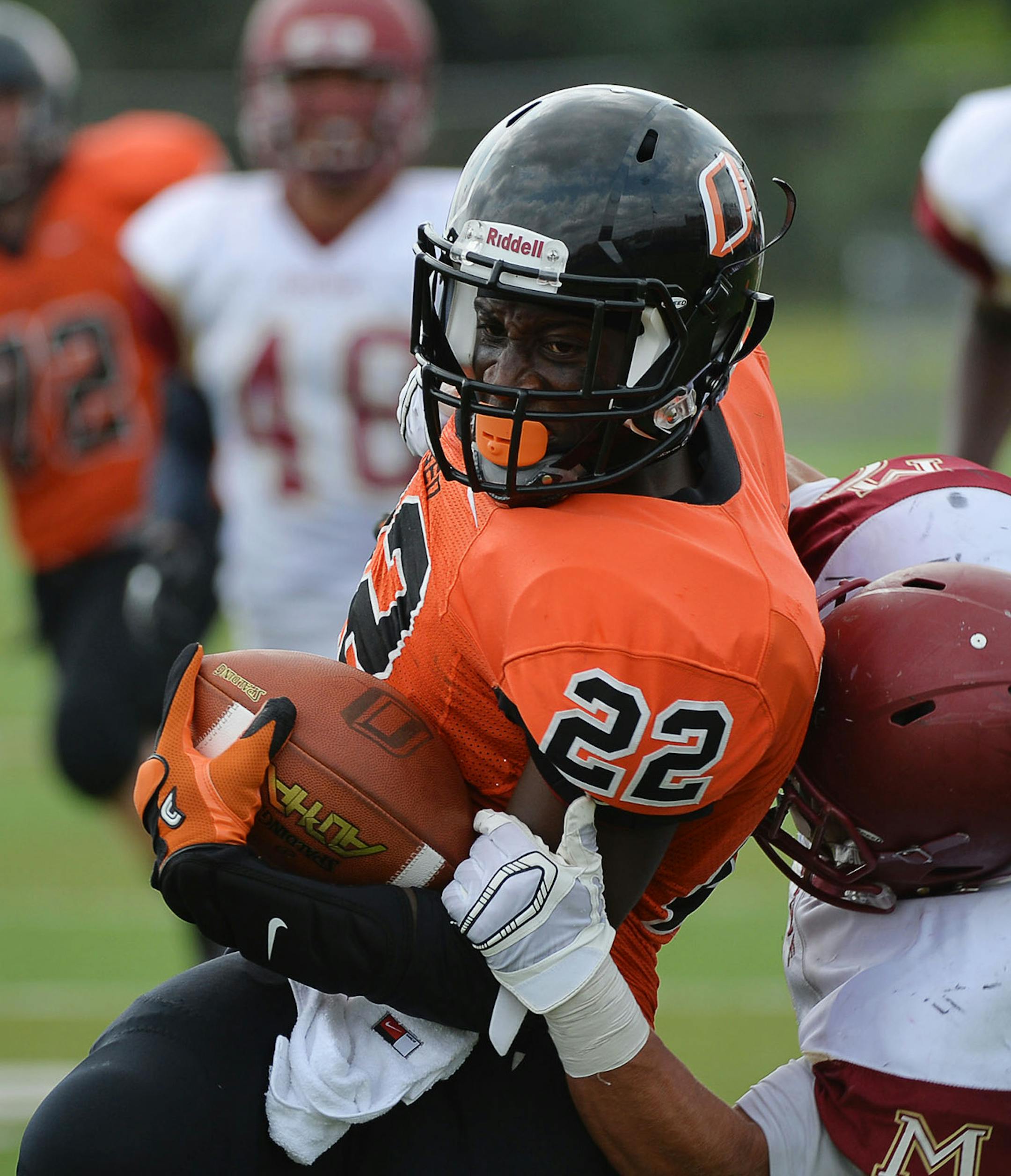 Osseo Running Back Prince G Kruah was almost tackled by Maple Grove Running Back/Defensive Back Isaac Collins during the 2nd quarter at the Maple Grove vs Osseo football game at Osseo High School in Osseo, Minn. on Saturday August 22, 2015. ] RACHEL WOOLF &#xb7; rachel.woolf@startribune.com Osseo defeated Maple Grove 22-15. ORG XMIT: MIN1508221730051690
