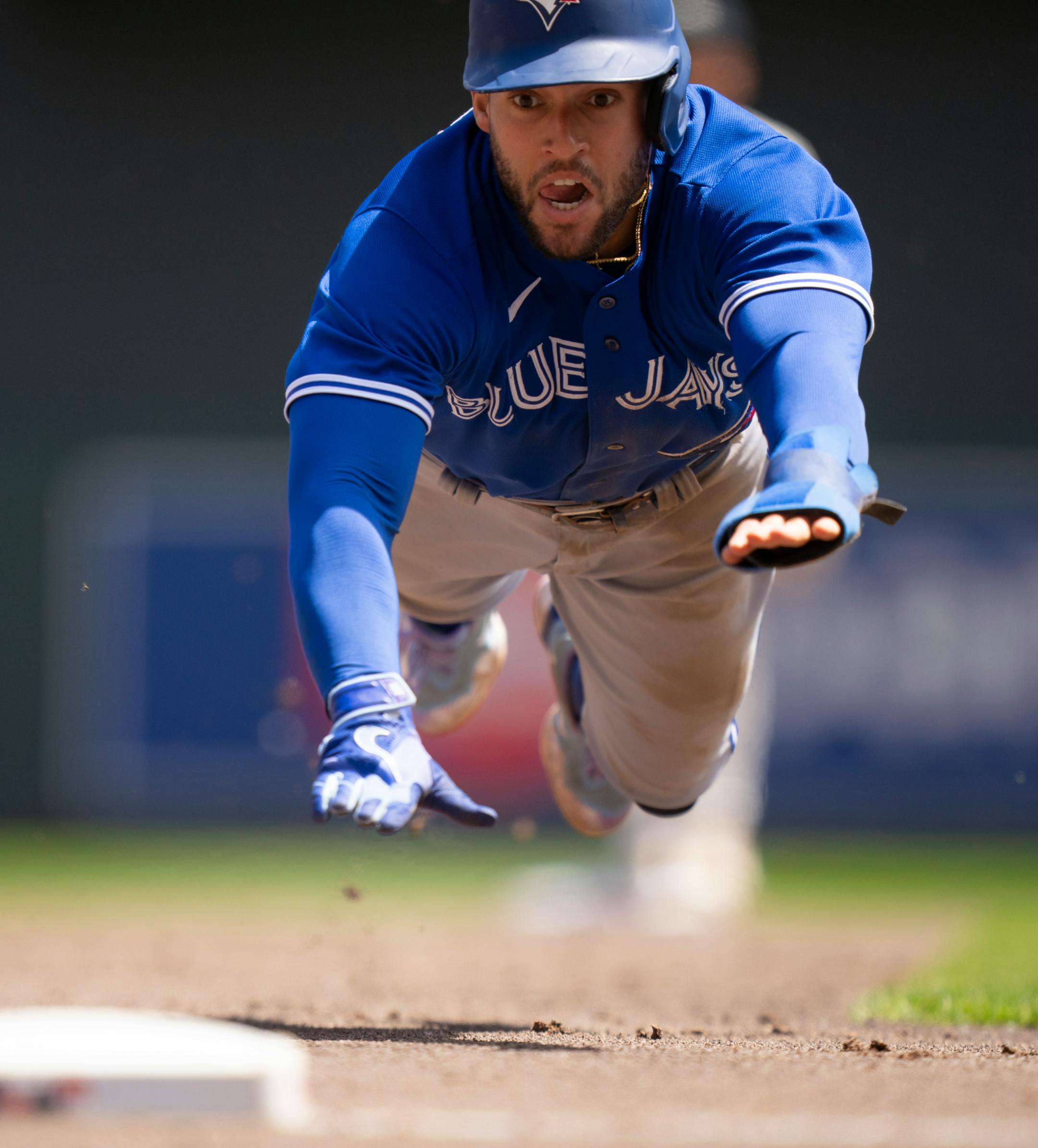 Toronto Blue Jays right fielder George Springer (4) dove safely into third base in the third inning.