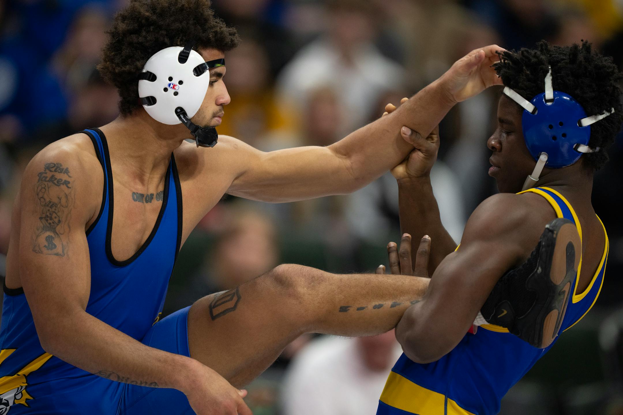 Jericho Cooper of Hastings, left, on his way to a 14-8 decison over Bryon Sauvy of St. Michael-Albertville in their 182 lb. match.