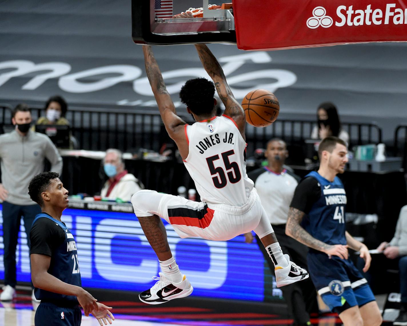 Portland Trail Blazers forward Derrick Jones Jr. dunks next to Minnesota Timberwolves forward Juancho Hernangomez, right, during the second half of an NBA basketball game in Portland, Ore., Thursday, Jan. 7, 2021. (AP Photo/Steve Dykes)