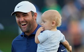 Scottie Scheffler holds his son, Bennett, after winning the PGA Championship at Quail Hollow on Sunday in Charlotte, N.C.