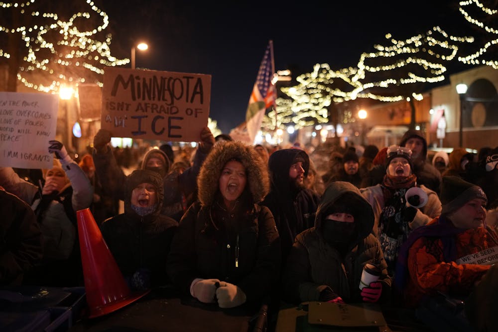 A crowd gathers for a candlelight vigil at 27th and Nicollet Avenue in the wake of the fatal shooting of Alex Pretti by a federal agent on Saturday.