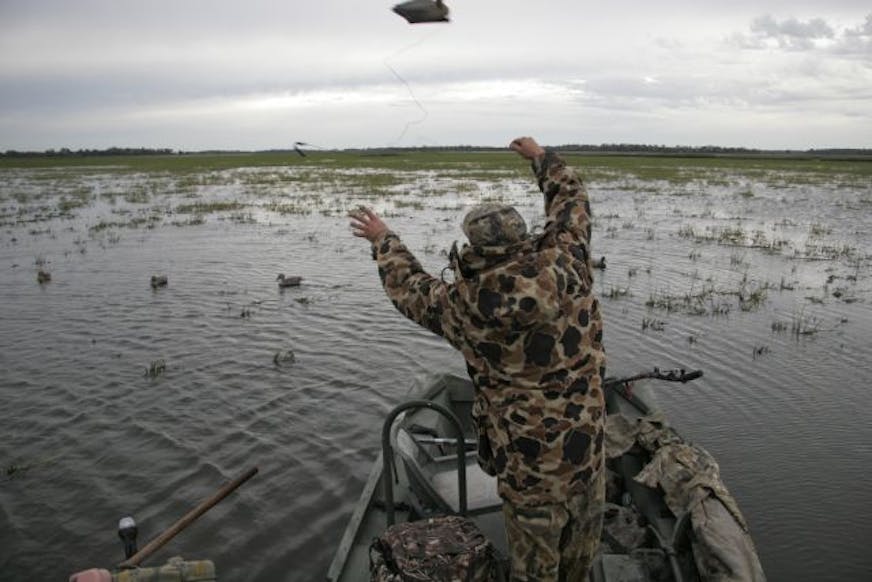 Doug Smith/Star Tribune Dan Kirchner of Mankato tosses decoys out for the duck opener Saturday on Swan Lake.
