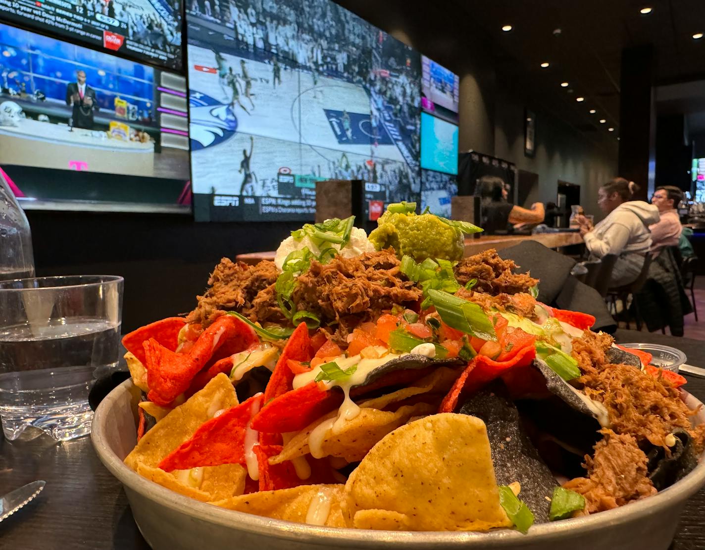 Patrons watch on multiple screens at Tom's Watch Bar during the Minnesota Lynx vs. New York Liberty game on Oct. 16 of the 2024 WNBA Playoffs Finals.