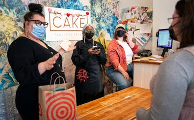 Minneapolis boutique Cake Plus-Sized Retail is one of the rare Twin Cities spots that still require masks. Customer Leora Feinstein, right, said that'