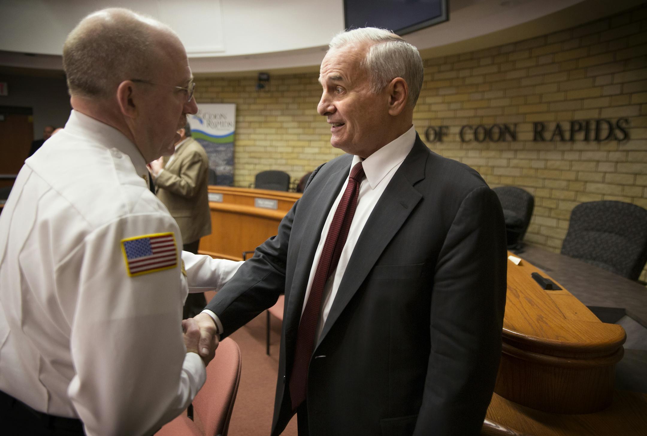 Governor Mark Dayton talks with Coon Rapids Fire Chief John Piper after meeting with local and state officials on the topic of railroad safety at the Coon Rapids City Center on Monday, December 22, 2014. ] LEILA NAVIDI leila.navidi@startribune.com /