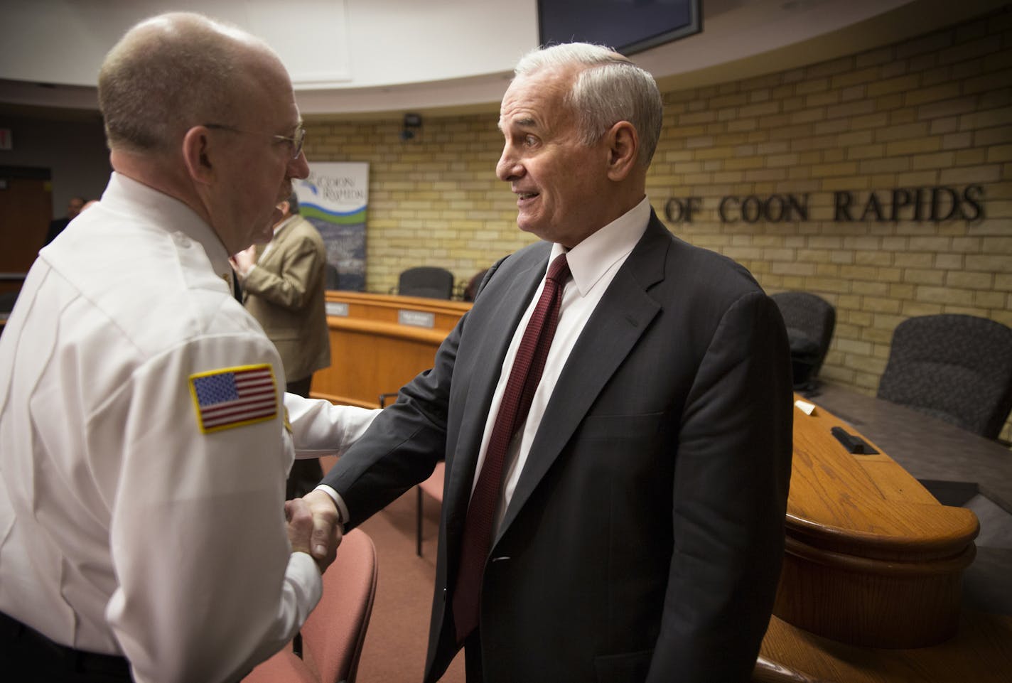 Governor Mark Dayton talks with Coon Rapids Fire Chief John Piper after meeting with local and state officials on the topic of railroad safety at the Coon Rapids City Center on Monday, December 22, 2014. ] LEILA NAVIDI leila.navidi@startribune.com /