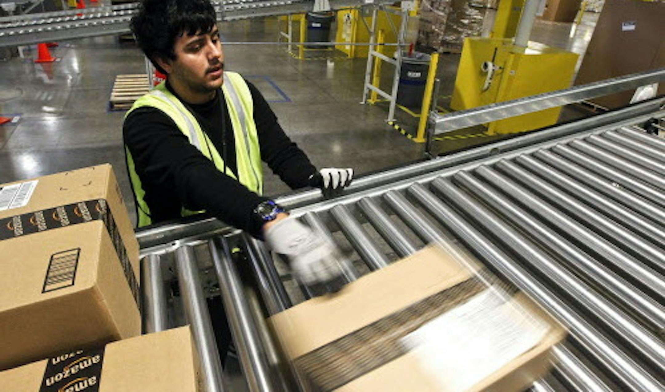 On "Cyber Monday" Rafael Moreno gets packages ready for shipping at the Amazon.com 1.2 million square foot fulfillment center Monday, Nov. 26, 2012, in Phoenix. Americans clicked away on their computers and smartphones for deals on Cyber Monday, which is expected to be the biggest online shopping day in history. Shoppers are expected to spend $1.5 billion, up 20 percent from last year, according to research firm comScore. That would not only make it the biggest online shopping day of the year, b