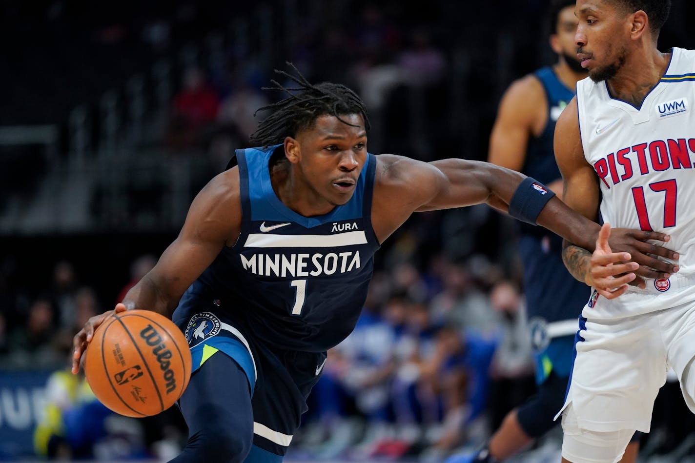 Timberwolves forward Anthony Edwards drives on Pistons guard Rodney McGruder in the first half Thursday