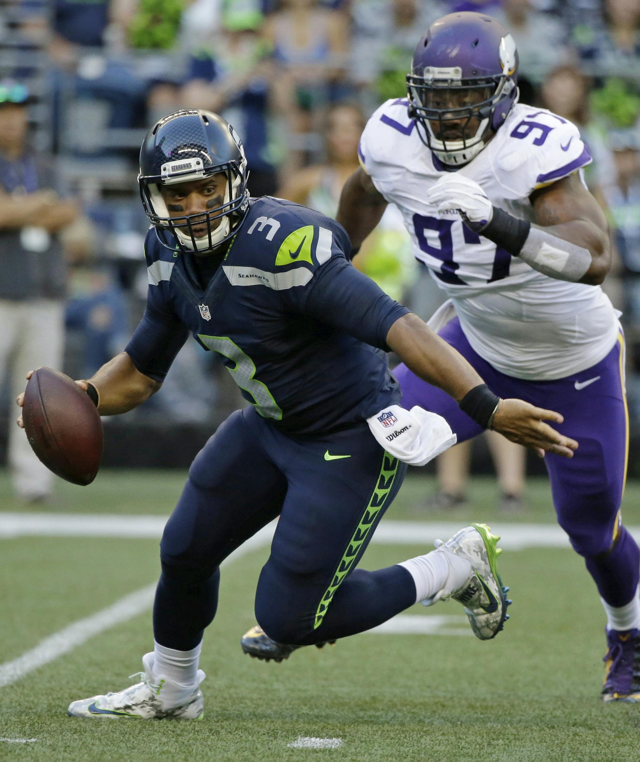Minnesota Vikings defensive end Everson Griffen (97) prepares to sack Seattle Seahawks quarterback Russell Wilson (3) during the first half of a preseason NFL football game, Thursday, Aug. 18, 2016, in Seattle. (AP Photo/Elaine Thompson)