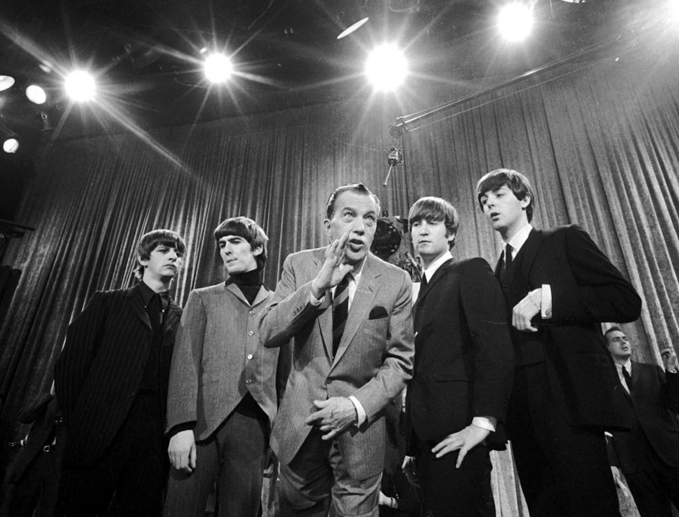 FILE - In this Feb. 9, 1964 file photo, Ed Sullivan, center, stands with The Beatles, from left, Ringo Starr, George Harrison, John Lennon, and Paul McCartney, during a rehearsal for the British group's first American appearance, on the "Ed Sullivan Show," in New York. CBS is planning a two-hour special on Feb. 9, 2014, to mark the 50th anniversary of the Beatles� groundbreaking first appearance on �The Ed Sullivan Show.�