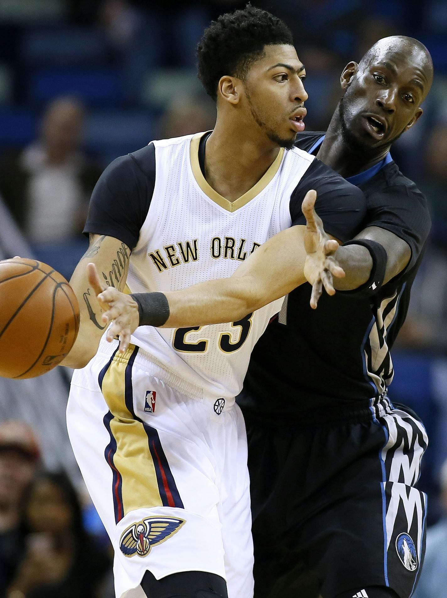 New Orleans Pelicans forward Anthony Davis, left, drives against Minnesota Timberwolves forward Kevin Garnett during the first half of an NBA basketball game Tuesday, Jan. 19, 2016, in New Orleans. (AP Photo/Jonathan Bachman)