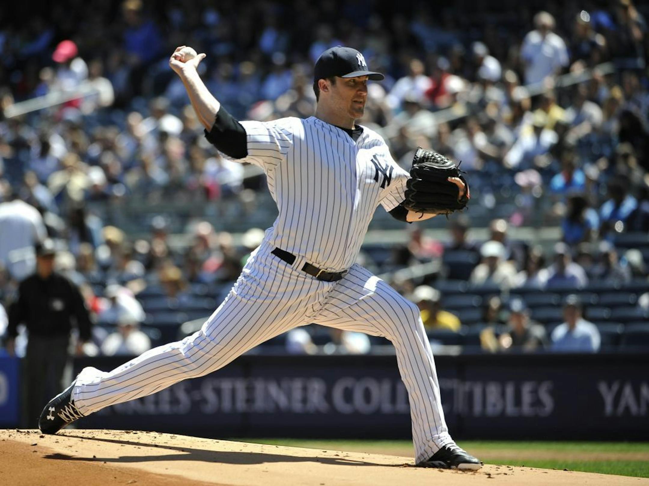New York Yankees starting pitcher Phil Hughes throws against the Oakland Athletics