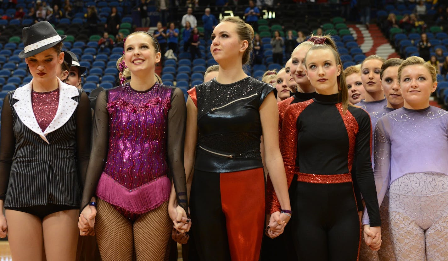 Lakeview South, Eastview, Eden Prairie, Wayzata, and Chaska dance teams all hold hands in protest prior to the announcement of awards for the 3AAA state dance team high kick division tournament in February at Target Center.