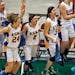 Esko players celebrate their victory at the final horn. ] Girls State High School Class 2A basketball tournament. New London - Spicer Wildcats vs. Esk